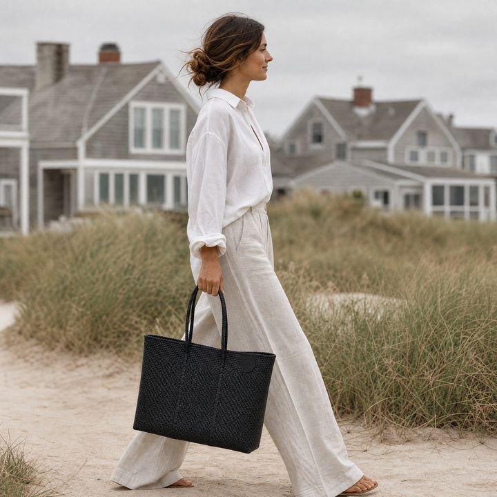 Model carrying Tin Marin Super Tote on beach coast