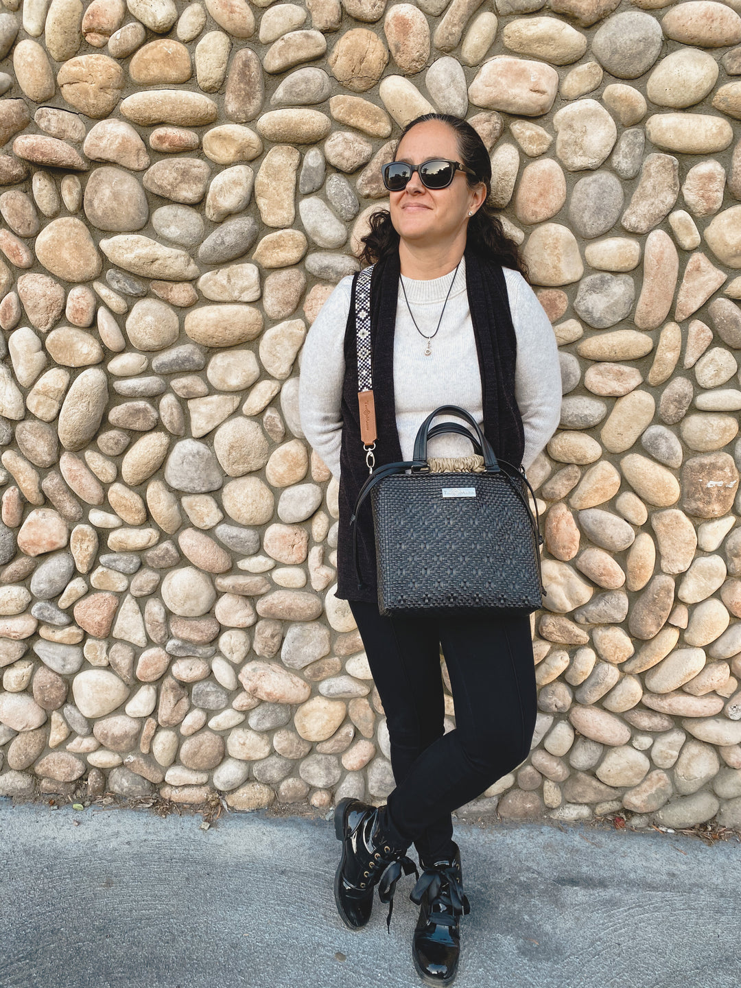 Woman wearing All black medium woven crossbody bag with mai woven strap — Tin Marin