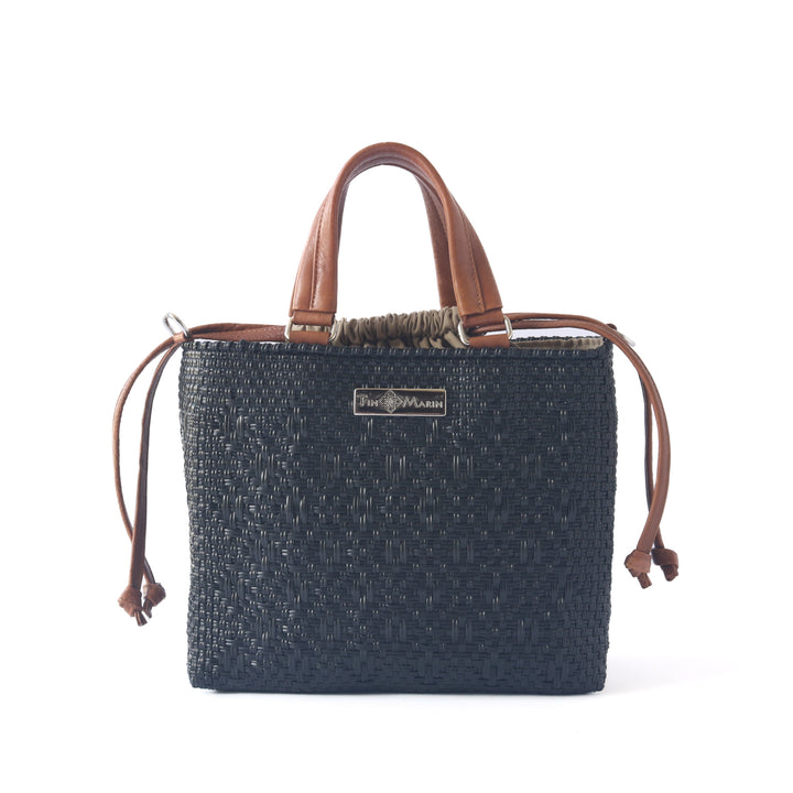 All black woven crossbody drawstring bag with tan leather — handmade from recycled plastic, Tin Marin