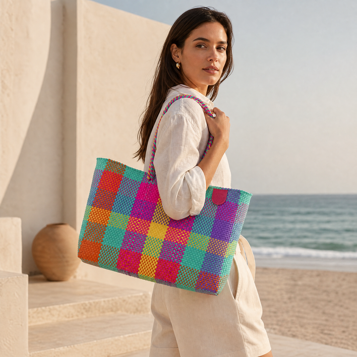 Model carrying Tin Marin Super Tote on beach coast