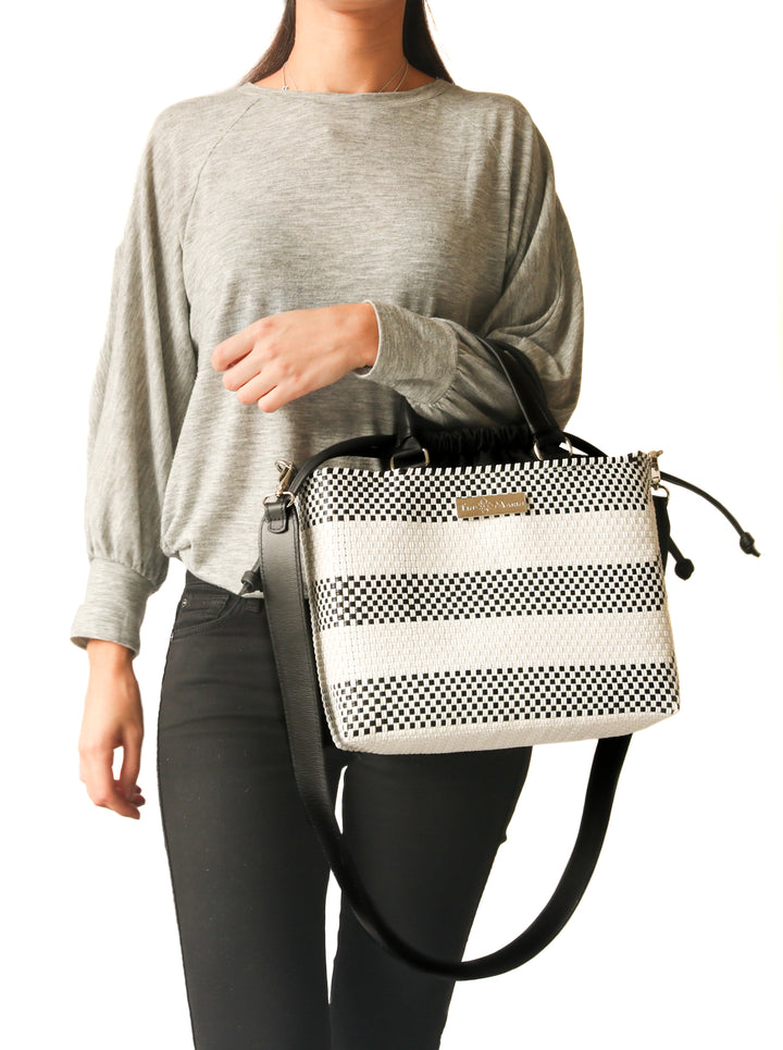 Woman wearing Lolo medium woven crossbody bag — Tin Marin