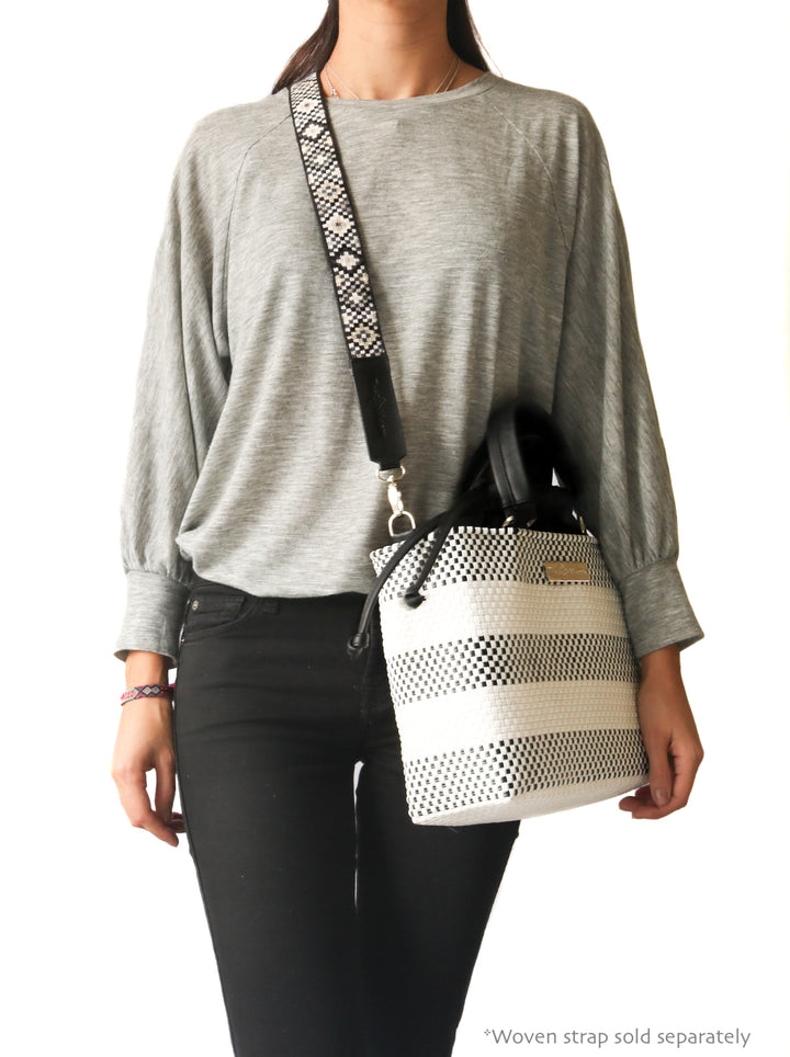 Woman wearing Lolo medium woven crossbody bag with Mai Woven Strap — Tin Marin