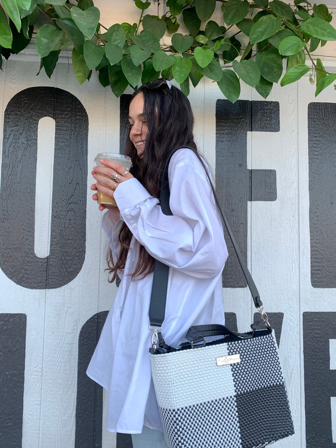 Woman wearing Lucy medium woven crossbody bag — Tin Marin