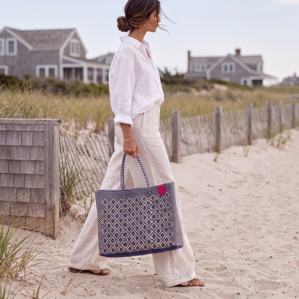 Model carrying Tin Marin Mixte Super Tote on beach coast