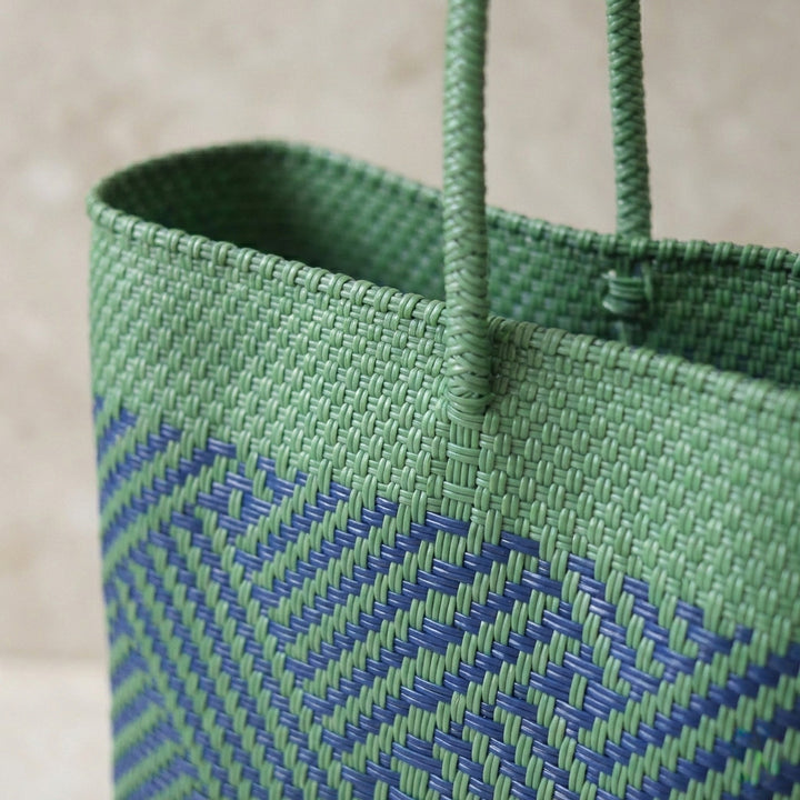 Close-up of handwoven green and blue palmera Super Tote by Tin Marin
