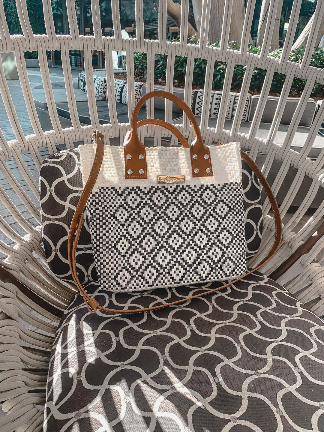 Tin Marin White Large woven crossbody bag in white and black with tan leather and crossbody strap— handmade from recycled plastic in Mexico by Tin Marin