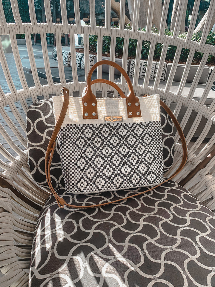 Tin Marin White Large woven crossbody bag in white and black with tan leather and crossbody strap— handmade from recycled plastic in Mexico by Tin Marin