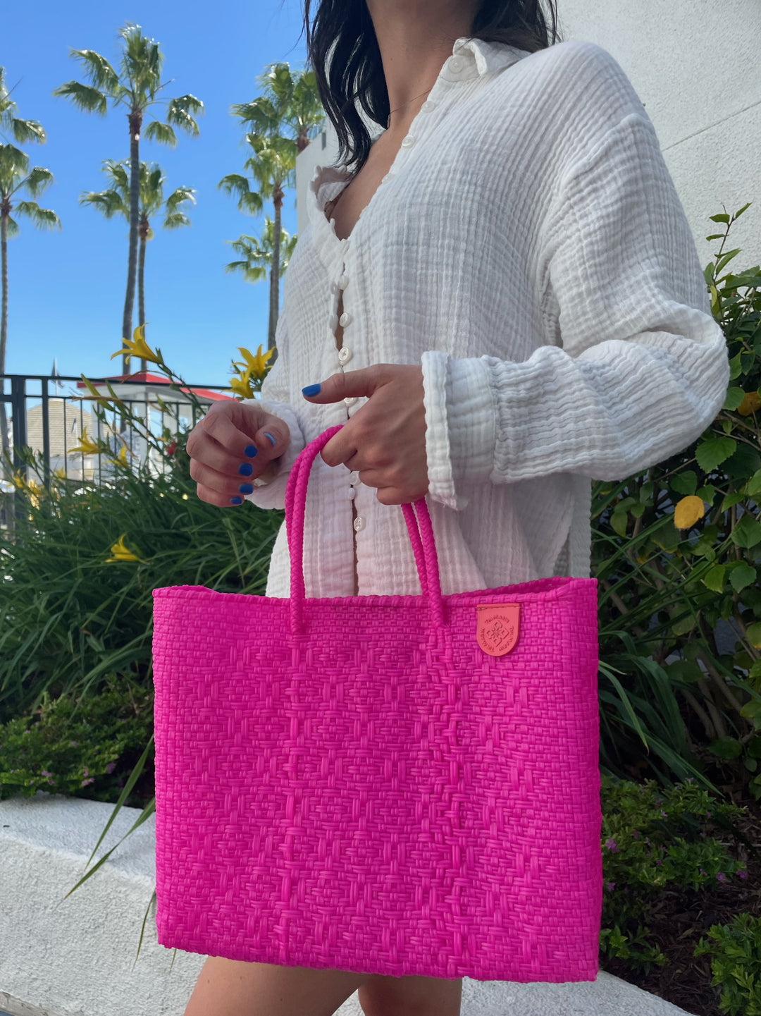 Vallarta woven crossbody bag styled for a beach or resort day — handmade by Tin Marin artisans