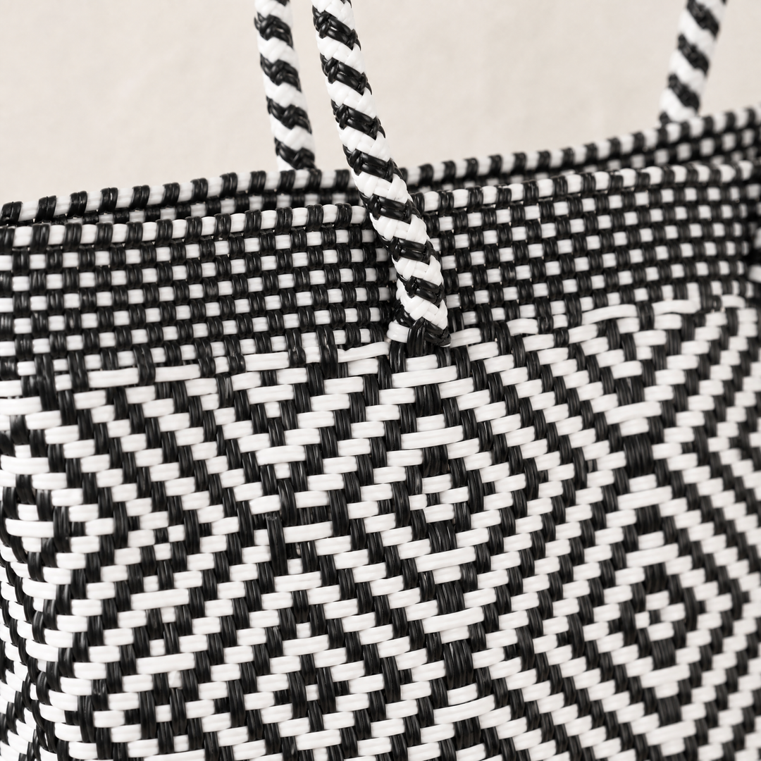 Close-up of handwoven black and white Greca Tote by Tin Marin