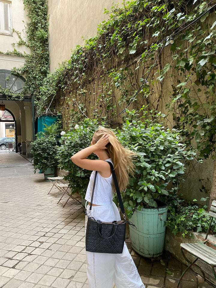 Woman wearing All Black medium woven crossbody bag — Tin Marin