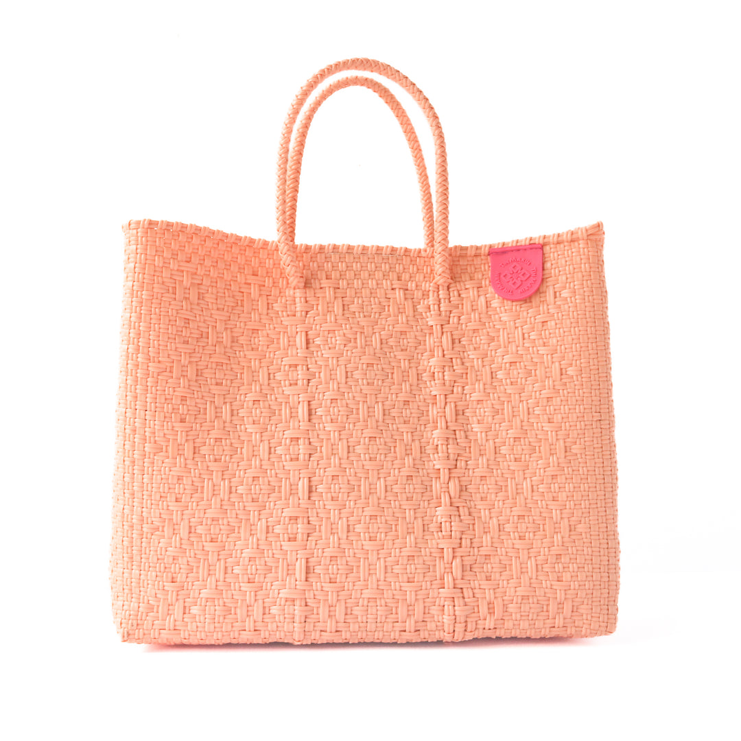 Vallarta medium woven crossbody bag in coral orange— handmade from recycled plastic in Mexico by Tin Marin