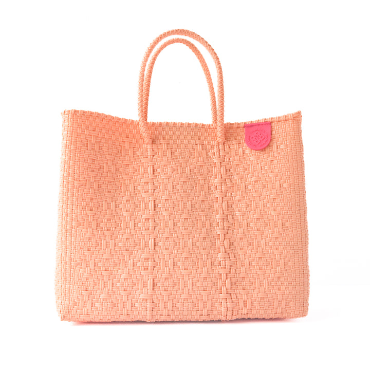 Vallarta medium woven crossbody bag in coral orange— handmade from recycled plastic in Mexico by Tin Marin