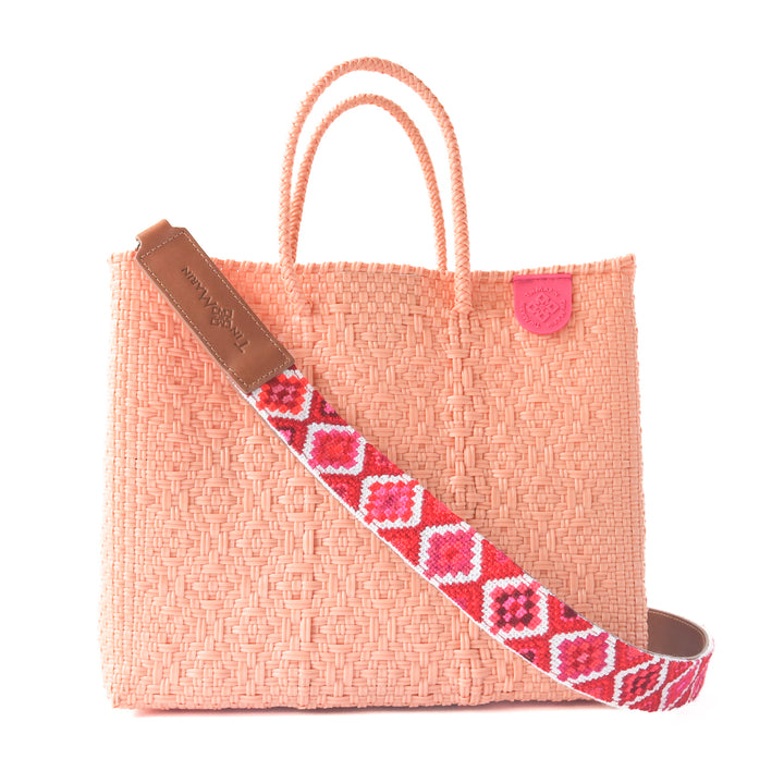 Canarias medium woven crossbody bag in coral orange— handmade from recycled plastic in Mexico by Tin Marin with embroidered mai woven strap