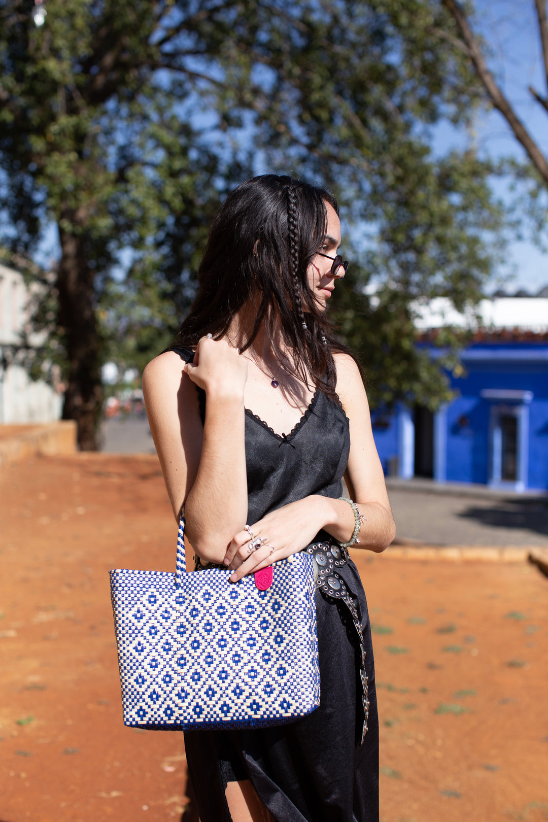 Woman wearing mixte medium woven crossbody bag — Tin Marin Resort Collection