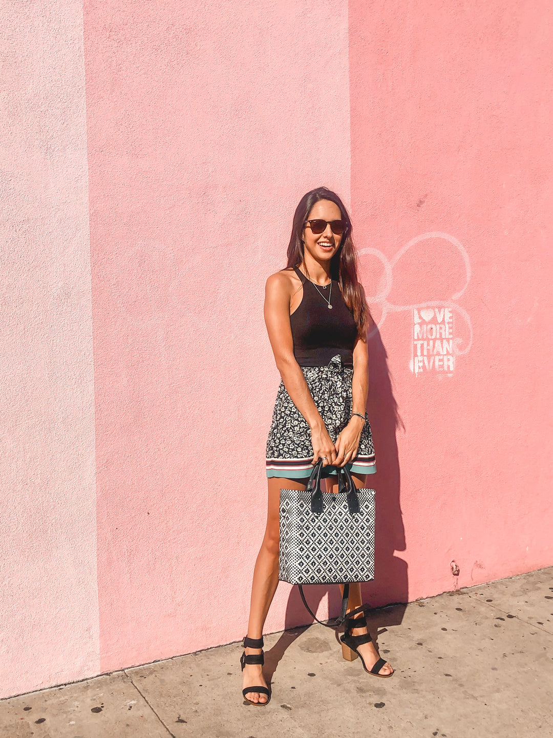 woman wearing Panda large woven crossbody bag in white and black with black leather- handmade from recycled plastic in Mexico by Tin Marin
