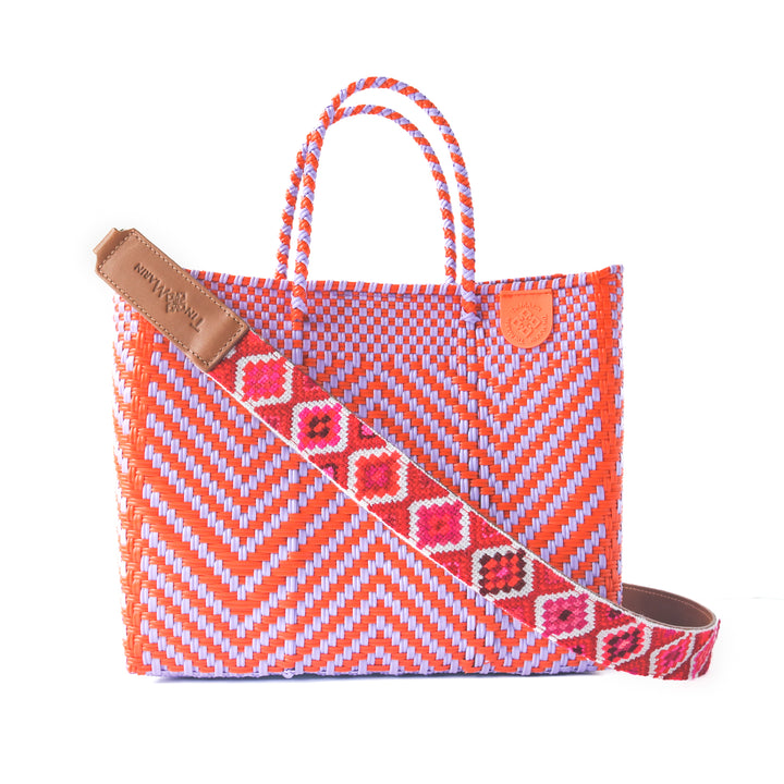 Positano medium woven crossbody bag in purple and orange — handmade from recycled plastic in Mexico by Tin Marin with embroidered mai woven strap