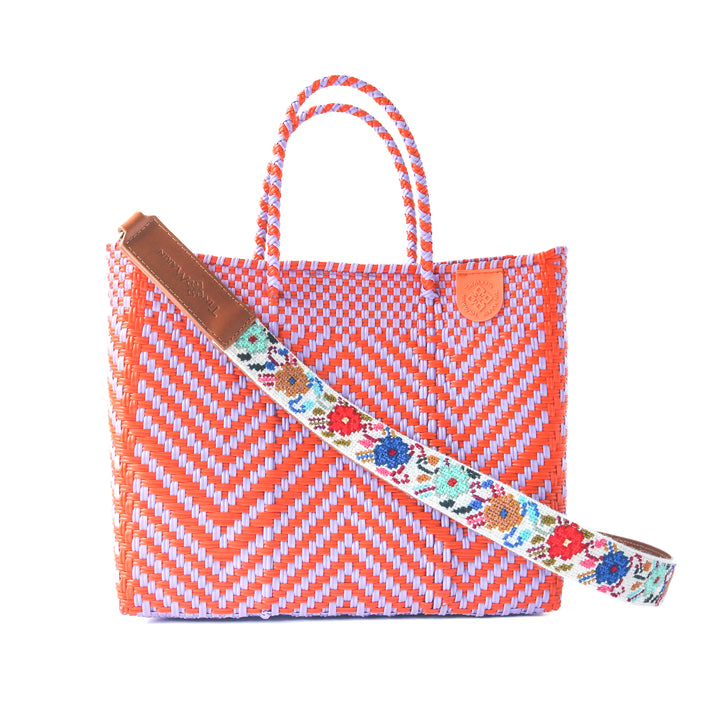 Positano medium woven crossbody bag in orange and purple— handmade from recycled plastic in Mexico by Tin Marin with embroidered mai woven strap