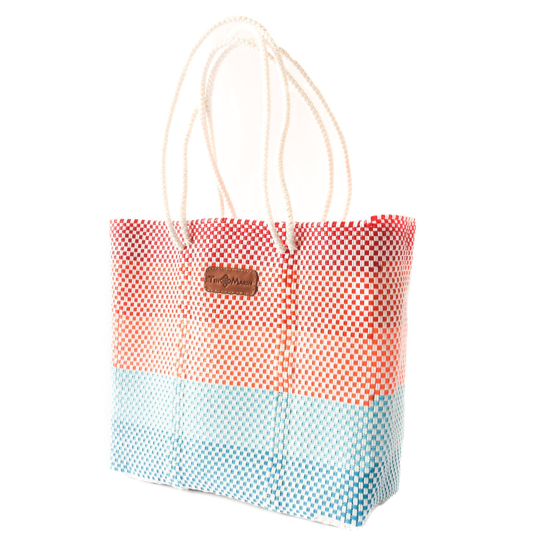 Side angle sunrise woven tote in multicolor— handmade from recycled plastic in Mexico by Tin Marin