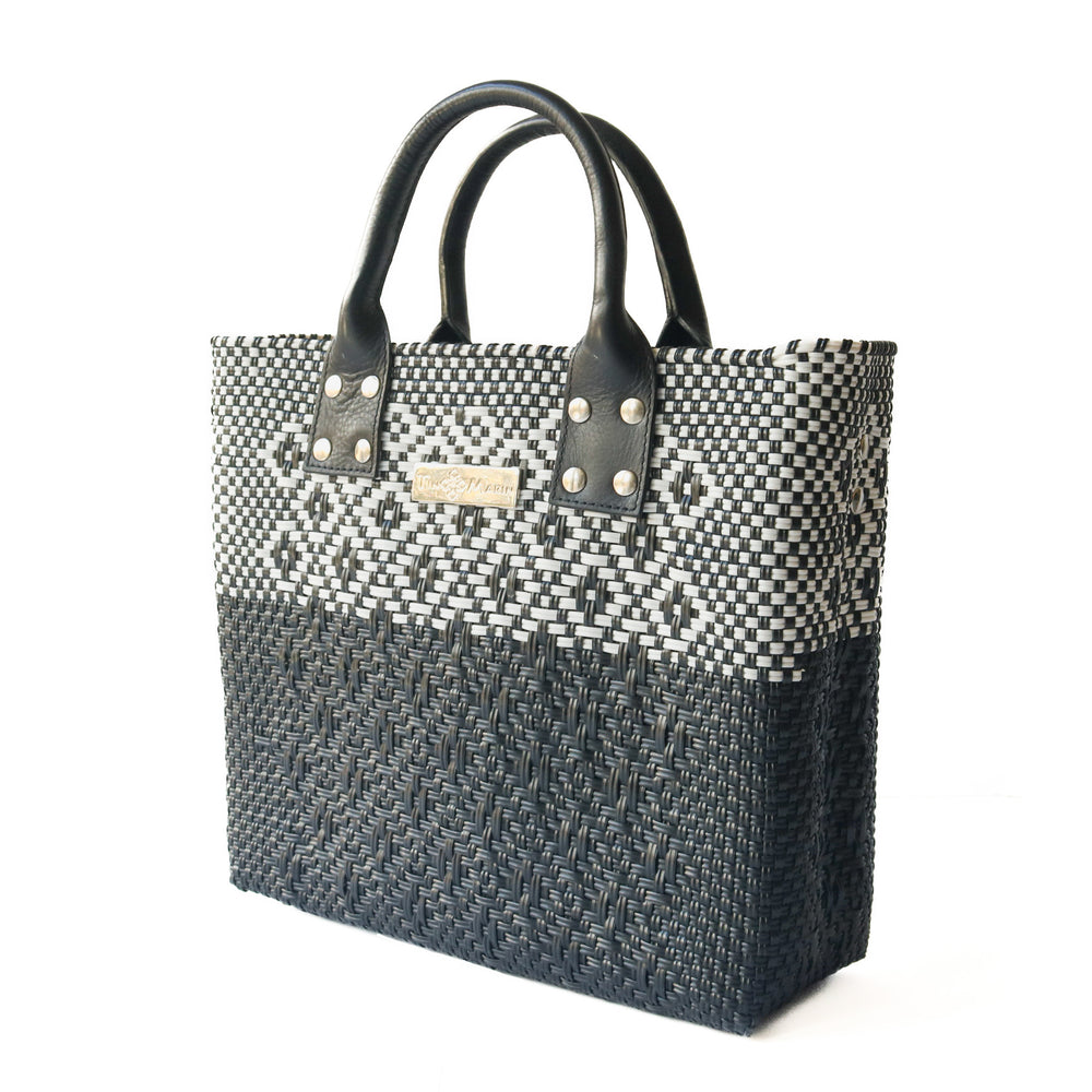 Side angle Tin Marin Black large woven crossbody bag in white and black— handmade from recycled plastic in Mexico by Tin Marin