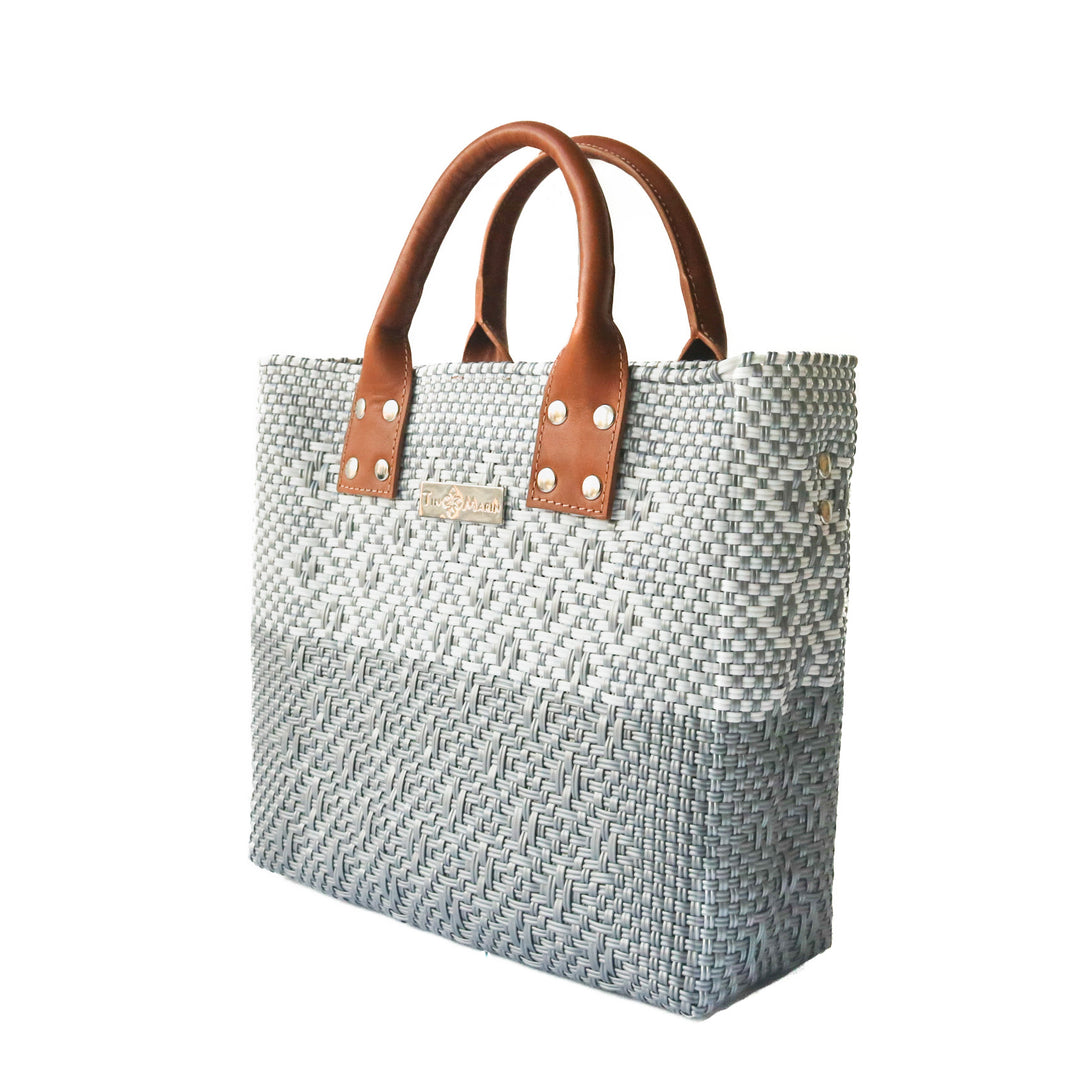 Side angle Tin Marin Grey Large woven crossbody bag in white and grey with tan leather— handmade from recycled plastic in Mexico by Tin Marin