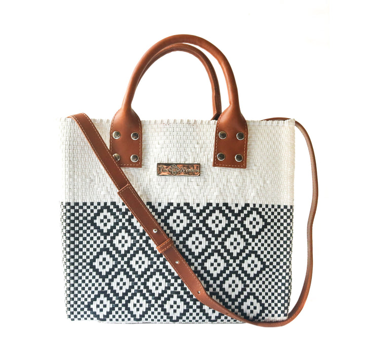 Tin Marin White Large woven crossbody bag in white and black with tan leather and crossbody strap— handmade from recycled plastic in Mexico by Tin Marin